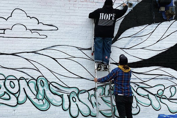 Photo of students painting a mural