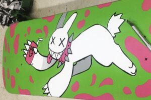 Skateboard with bunny painted on it